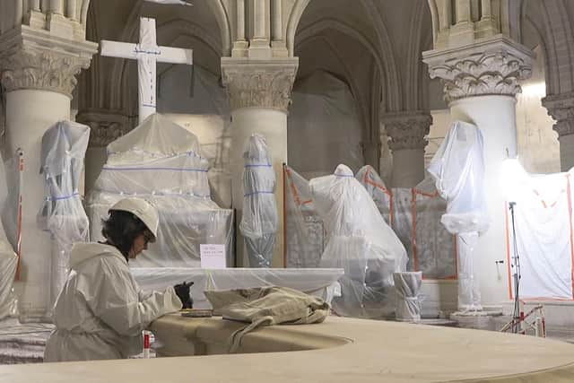 A worker restoring a balustrade inside the cathedral