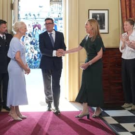 Staff applaud as new Prime Minister Andy Burnham and his wife Marie-France van Heel walk into 10 Downing Street (Picture: Kin Cheung/ POOL/AFP via Getty)