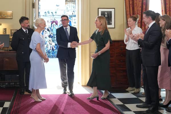 Staff applaud as new Prime Minister Andy Burnham and his wife Marie-France van Heel walk into 10 Downing Street (Picture: Kin Cheung/ POOL/AFP via Getty)
