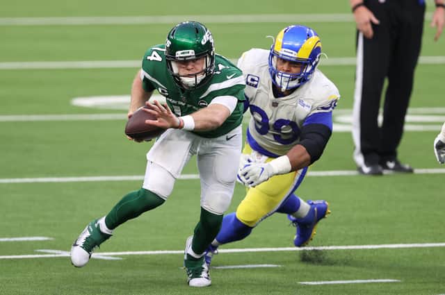 Sam Darnold of the New York Jets scrambles out of the pocket as Aaron Donald of the Los Angeles Rams tries to catch him. Picture: Sean M Haffey/Getty Images