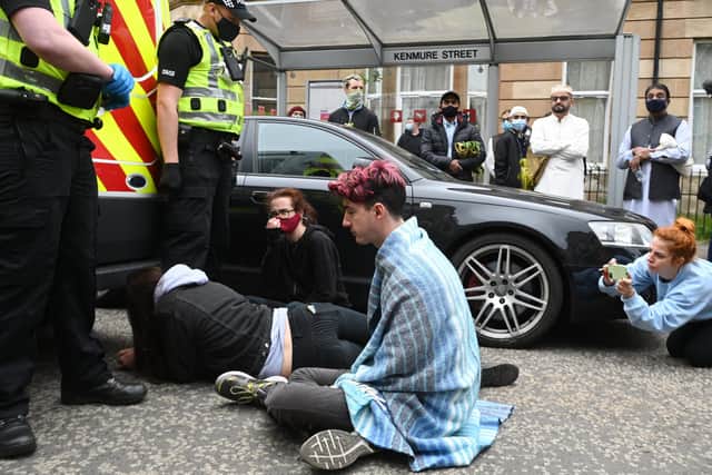 A number of protesters have put themselves in the path of the van
