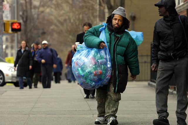 A homeless man collects bottles and cans to exchange for cash at a recycling centre in New York City (Picture: Mario Tama/Getty Images)