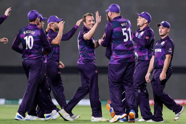 Scotland's players celebrate after the dismissal of Bangladesh's Liton Das during the ICC mens Twenty20 World Cup cricket match between Bangladesh and Scotland at the Oman Cricket Academy Ground in Muscat on October 17, 2021. (Photo by HAITHAM AL-SHUKAIRI/AFP via Getty Images)