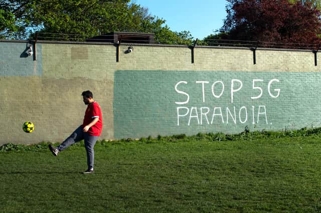 A plea for sanity over false claims about 5G and Covid is made in graffiti (Picture: Victoria Jones/PA)