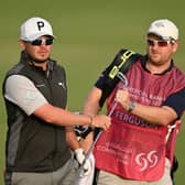 Ewen Ferguson hands a club to of caddie and fellow Scot Stephen Neilson during the first round of the Commercial Bank Qatar Masters at Doha Golf Club. Picture: Stuart Franklin/Getty Images.