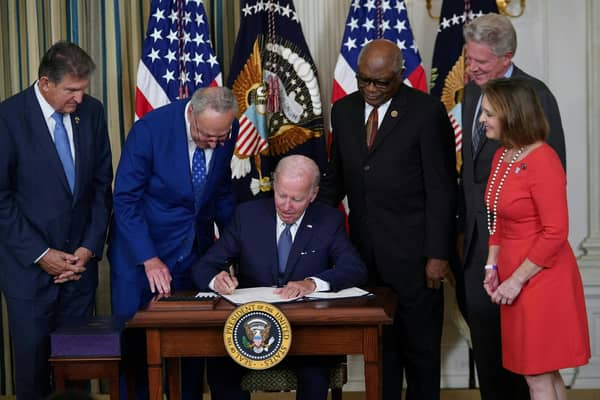US President Joe Biden signs the Inflation Reduction Act, which includes the biggest package of climate change measures in US history, in August last year (Picture: Mandel Ngan/AFP via Getty Images)
