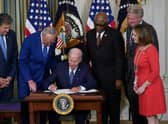 US President Joe Biden signs the Inflation Reduction Act, which includes the biggest package of climate change measures in US history, in August last year (Picture: Mandel Ngan/AFP via Getty Images)