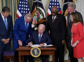 US President Joe Biden signs the Inflation Reduction Act, which includes the biggest package of climate change measures in US history, in August last year (Picture: Mandel Ngan/AFP via Getty Images)