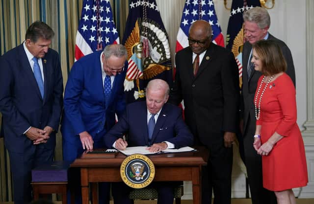 US President Joe Biden signs the Inflation Reduction Act, which includes the biggest package of climate change measures in US history, in August last year (Picture: Mandel Ngan/AFP via Getty Images)