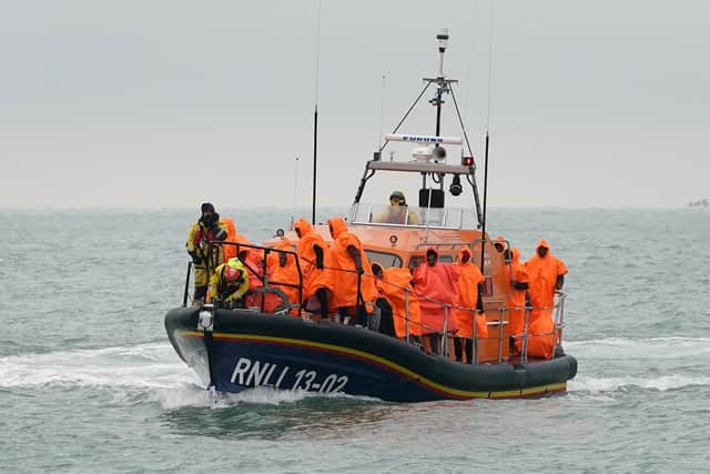 A group of people thought to be migrants are brought in to Dungeness, Kent, after being rescued by the RNLI following a small boat incident in the Channel on December 9. Stock photo not from current incident.