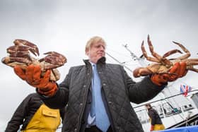 Boris Johnson poses with two crabs at Stromness harbour, but by getting Brexit done, he has damaged Scotland's food-and-drink industry (Picture: Robert Perry/WPA pool/Getty Images)