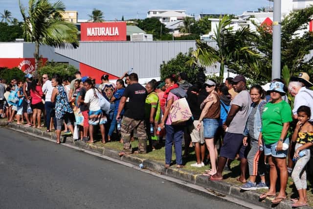 People queue to enter a supermarket to purchase groceries and food in the Magenta district of Noumea, France's Pacific territory of New Caledonia, where anger over France's plan to impose new voting rules has spiralled into the deadliest violence in four decades in the archipelago of 270,000 people, which lies between Australia and Fiji.