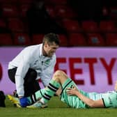 Hibs striker Kevin Nisbet received treatment for a hamstring issue during the match against Ross County.