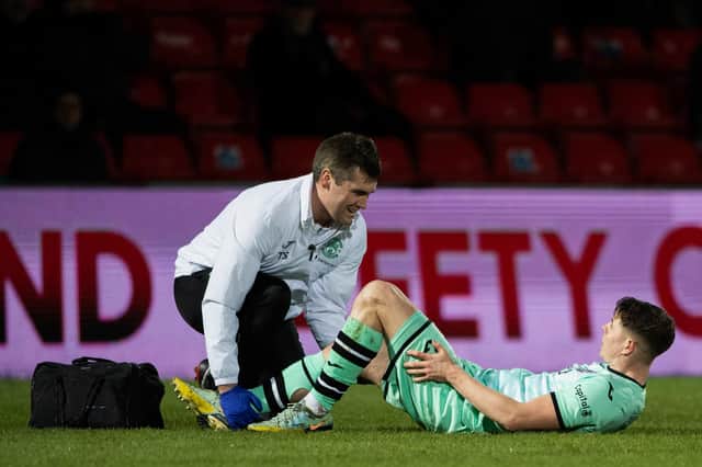 Hibs striker Kevin Nisbet received treatment for a hamstring issue during the match against Ross County.
