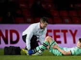 Hibs striker Kevin Nisbet received treatment for a hamstring issue during the match against Ross County.