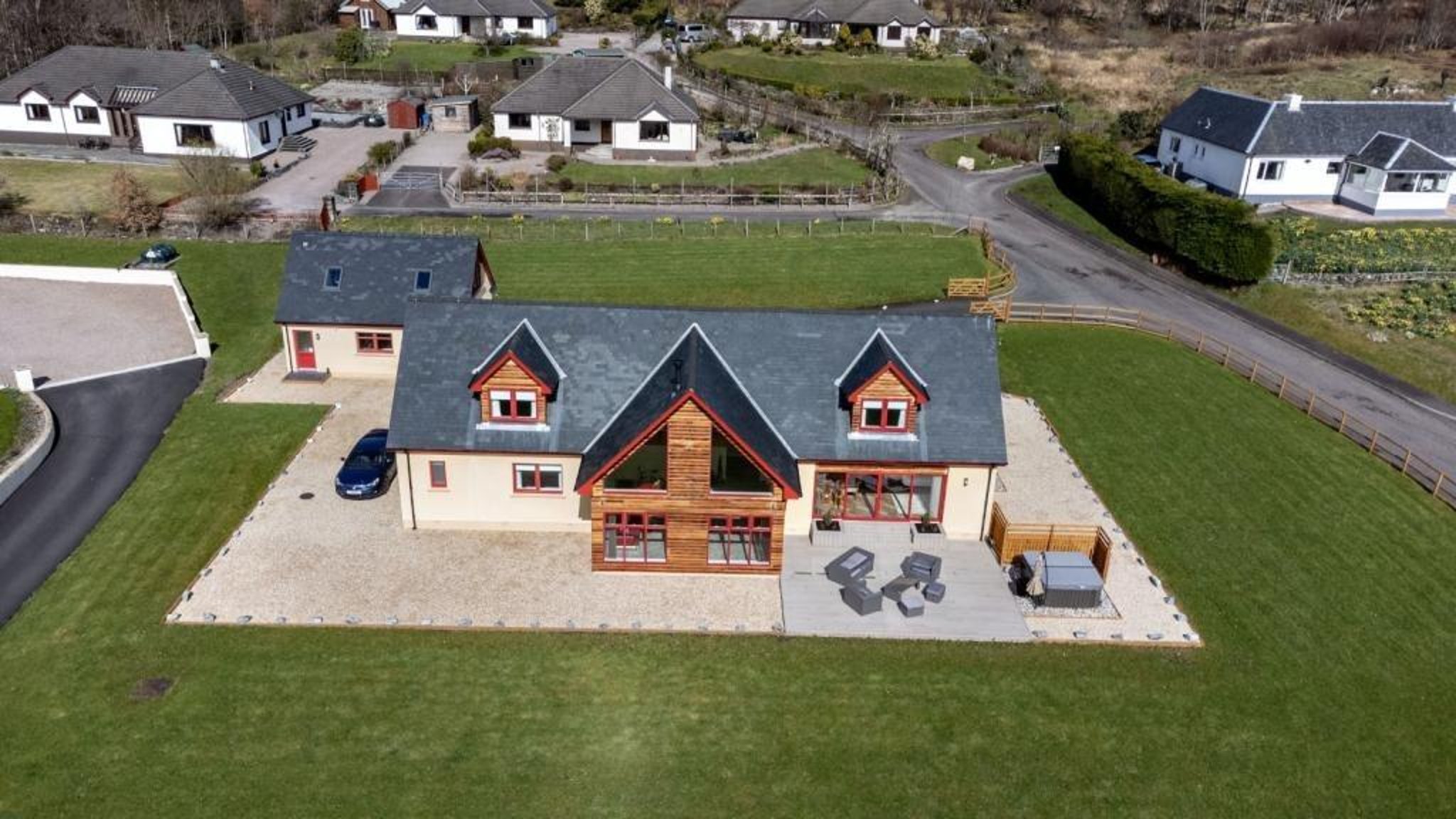This striking and light-filled 5-bedroom modern Highland haven sits in an elevated lochside position with stunning views