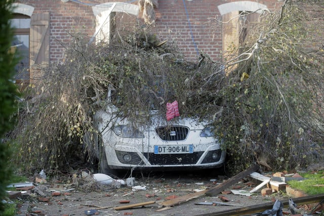 A downed tree lays on top of a car after a tornado struck the area in Bihucourt, northern France. The firefighter service in the Pas-de-Calais region described “tornado-type” winds that hit Bihucourt, Ervillers and Hendecourt-les-Cagnicourt.

 (AP Photo/Michel Spingler)