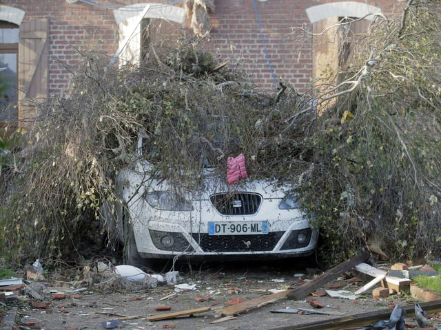 A downed tree lays on top of a car after a tornado struck the area in Bihucourt, northern France. The firefighter service in the Pas-de-Calais region described “tornado-type” winds that hit Bihucourt, Ervillers and Hendecourt-les-Cagnicourt.
(AP Photo/Michel Spingler)