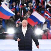 Vladimir Putin addressed a crowd of flag-waving supporters at the Luzhniki stadium in Moscow (Picture: Sergei Guneyev/pool/AFP via Getty Images)