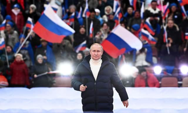 Vladimir Putin addressed a crowd of flag-waving supporters at the Luzhniki stadium in Moscow (Picture: Sergei Guneyev/pool/AFP via Getty Images)