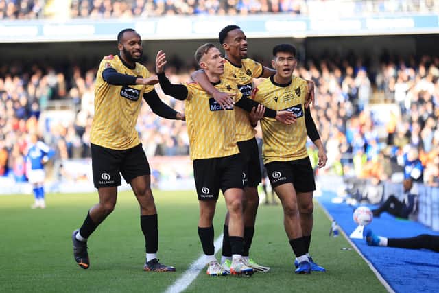Sam Corne of Maidstone United celebrates with team-mates after defeating Ipswich in the FA Cup.