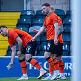 Dundee United's Tony Watt picks up a glass bottle thrown by an away fan after his first goal in the 2-0 win over Raith Rovers   (Photo by Ewan Bootman / SNS Group)