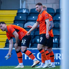 Dundee United's Tony Watt picks up a glass bottle thrown by an away fan after his first goal in the 2-0 win over Raith Rovers   (Photo by Ewan Bootman / SNS Group)