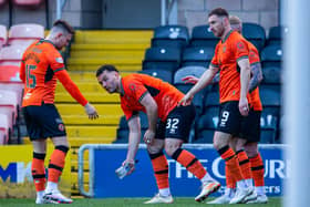 Dundee United's Tony Watt picks up a glass bottle thrown by an away fan after his first goal in the 2-0 win over Raith Rovers   (Photo by Ewan Bootman / SNS Group)