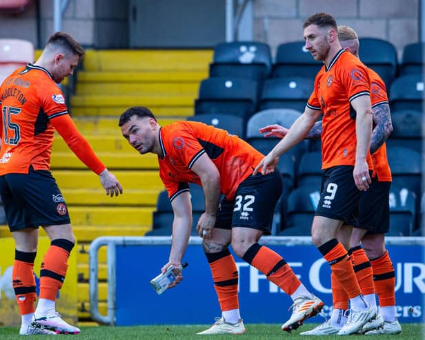 Dundee United's Tony Watt picks up a glass bottle thrown by an away fan after his first goal in the 2-0 win over Raith Rovers   (Photo by Ewan Bootman / SNS Group)