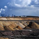 Trucks drive near the Neurath coal-fired power station and the open-cast mine at Garzweiler in western Germany (Picture: Ina Fassbender/AFP via Getty Images)