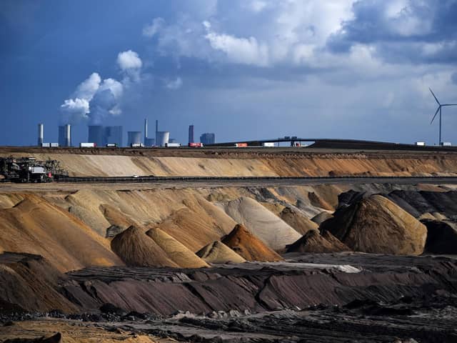 Trucks drive near the Neurath coal-fired power station and the open-cast mine at Garzweiler in western Germany (Picture: Ina Fassbender/AFP via Getty Images)