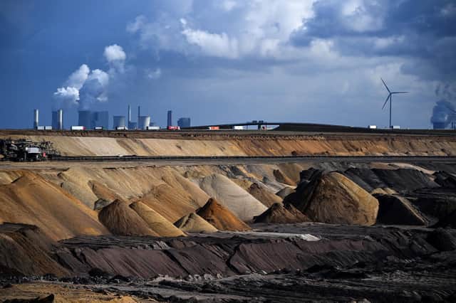 Trucks drive near the Neurath coal-fired power station and the open-cast mine at Garzweiler in western Germany (Picture: Ina Fassbender/AFP via Getty Images)