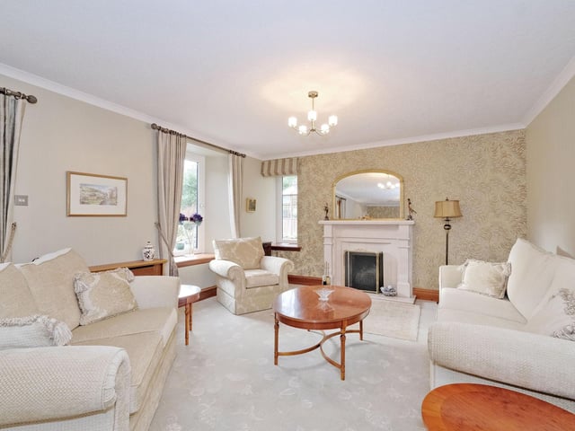 Interior: A south-facing office overlooks exceptional grounds. There is an open-plan kitchen and breakfast nook, sun room with wood-burner, and a kitchen-dining room. One staircase leads to two of the bedrooms, while the another two are accessed via the first-floor family room.