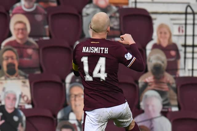 Steven Naismith celebrates in front of the cardboard fans after opening the scoring.