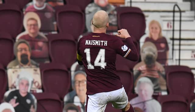 Steven Naismith celebrates in front of the cardboard fans after opening the scoring.