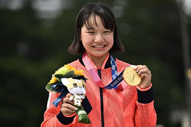 Japan's Momiji Nishiya poses with her gold medal after the skateboarding women's street final