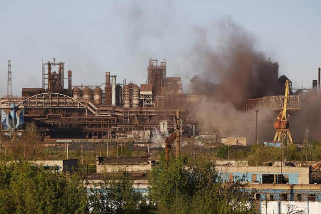 Smoke rises from the Metallurgical Combine Azovstal in Mariupol during shelling, in Mariupol, in territory under the government of the Donetsk People's Republic, eastern Ukraine, Saturday, May 7, 2022. Russia-backed separatists in eastern Ukraine say that at least 40 Ukrainian prisoners of war captured during the fighting for Mariupol have been killed by Ukrainian shelling. (AP Photo/Alexei Alexandrov, File)