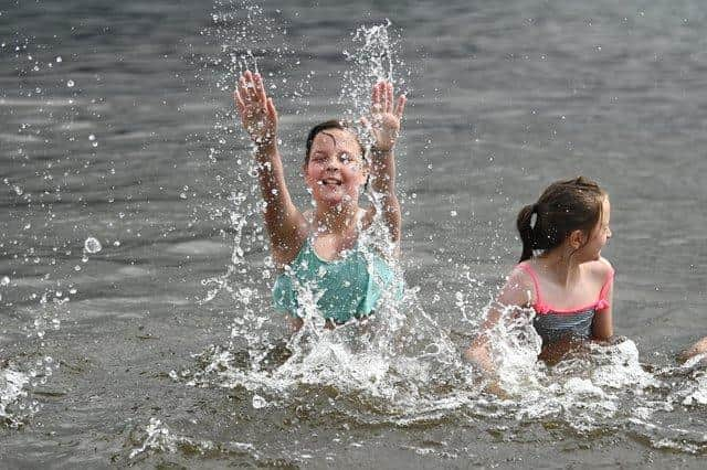 Two young girls cooling off in a loch in Scotland picture: John Devlin