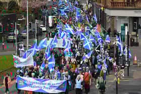 Protesters wave Scottish flags and hold placards as they march in support of Scottish independence in Glasgow earlier this year (Picture: Andy Buchanan/AFP via Getty Images)