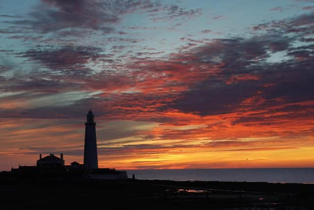 A orange sky just before sunrise at St Mary's Lighthouse in Whitley Bay. Picture date: Tuesday August 9, 2022.