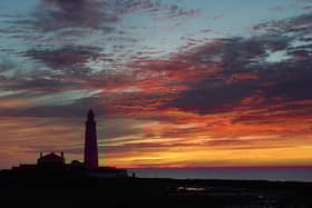 A orange sky just before sunrise at St Mary's Lighthouse in Whitley Bay. Picture date: Tuesday August 9, 2022.