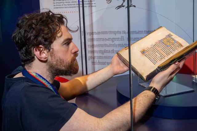 Conservation exhibitions specialist Ryan Gibson installing the Iona Psalter at the new Treasures gallery at the National Library of Scotland. Picture: Neil Hanna