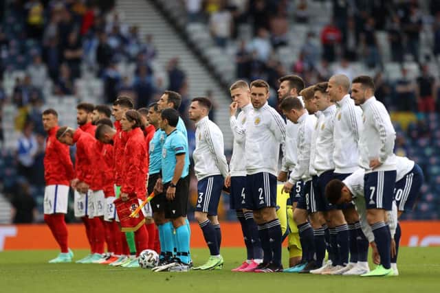 Andrew Robertson, Scott McTominay and team mates of Scotland stand for the national anthem prior to the UEFA Euro 2020 Championship Group D match between Croatia and Scotland at Hampden Park on June 22, 2021 in Glasgow, Scotland. (Photo by Lee Smith - Pool/Getty Images)
