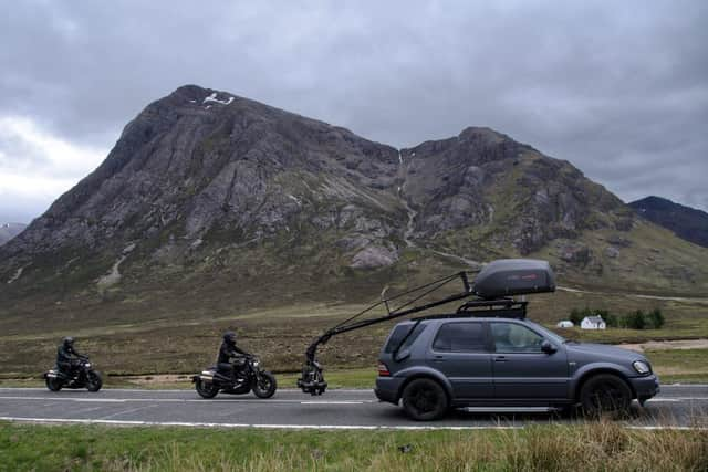 Two stunt workers can be seen racing each other on motorbikes, which appear to be from the World War Two era, behind a vehicle with a large camera rig. Photo: Tony Featherstone / SWNS.COM