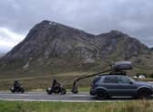 Two stunt workers can be seen racing each other on motorbikes, which appear to be from the World War Two era, behind a vehicle with a large camera rig. Photo: Tony Featherstone / SWNS.COM
