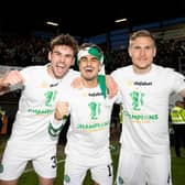Celtic's: Matt O'Riley (left), Jota and Carl Starfelt celebrate clinching the league at Tannadice on Wednesday night. The 21-year-old  maintains the camaradrie between an entire squad that are all friends has been reflected in their Premiership winning performances. (Photo by Craig Williamson / SNS Group)