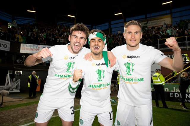 Celtic's: Matt O'Riley (left), Jota and Carl Starfelt celebrate clinching the league at Tannadice on Wednesday night. The 21-year-old  maintains the camaradrie between an entire squad that are all friends has been reflected in their Premiership winning performances. (Photo by Craig Williamson / SNS Group)