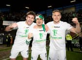 Celtic's: Matt O'Riley (left), Jota and Carl Starfelt celebrate clinching the league at Tannadice on Wednesday night. The 21-year-old  maintains the camaradrie between an entire squad that are all friends has been reflected in their Premiership winning performances. (Photo by Craig Williamson / SNS Group)