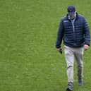 Dundee managing director John Nelms checks the pitch at Dens Park.