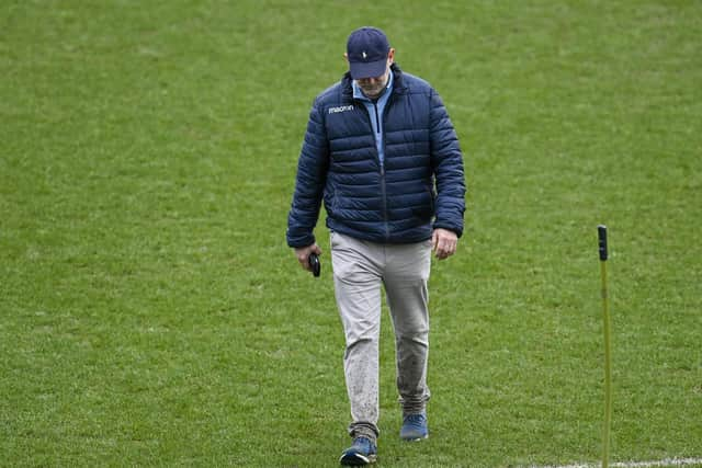 Dundee managing director John Nelms checks the pitch at Dens Park.